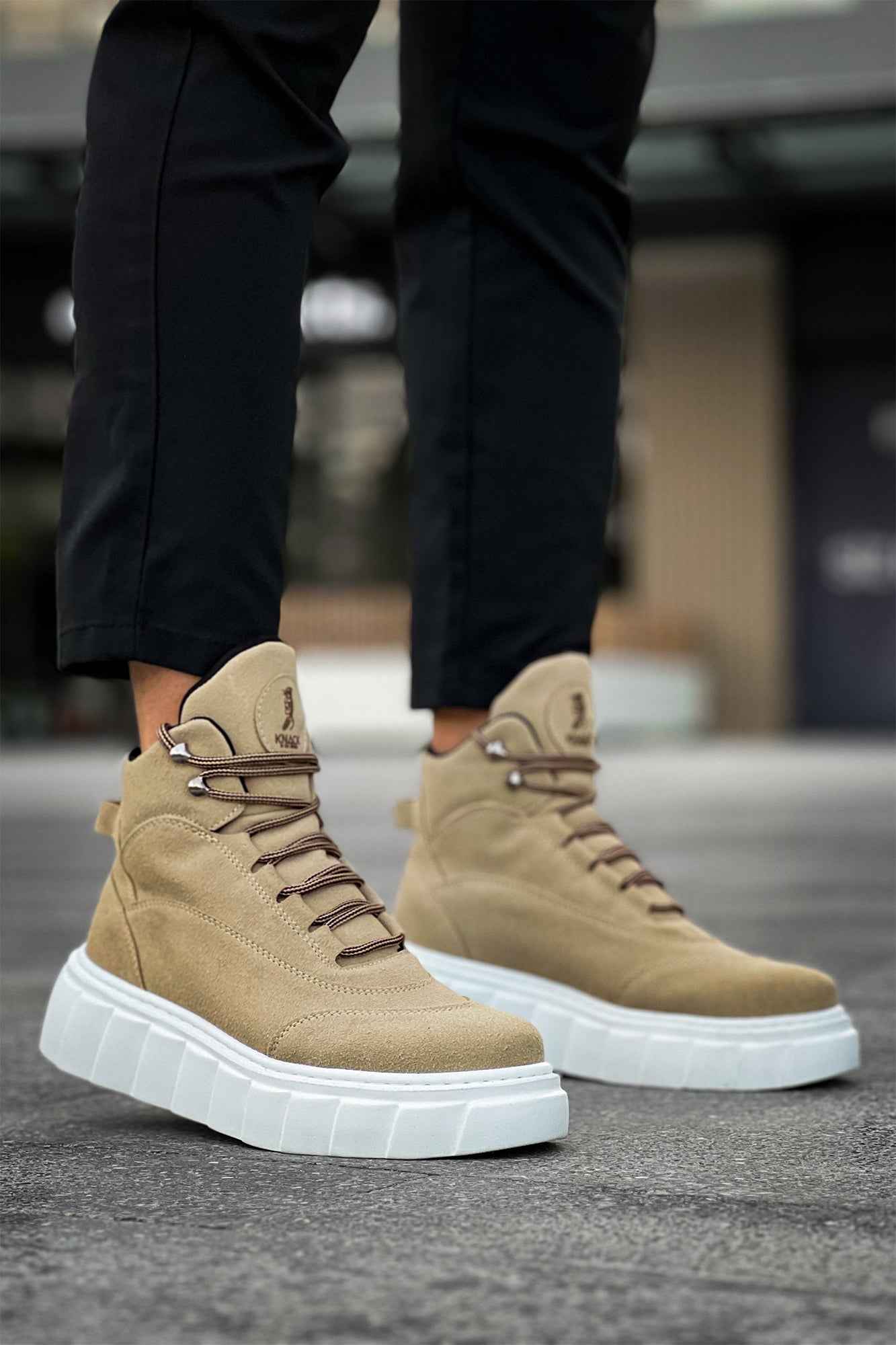 Beige suede high-top boots with lace-up front and heel tab, white platform sole