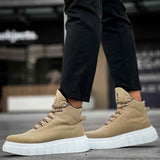 Beige suede lace-up platform boots with white sole, side view on pavement