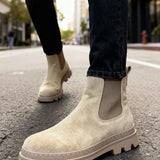 Men's beige suede ankle boots with elastic gore and chunky tread sole.