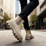 Men's beige suede boots, side view, with elastic panel and lugged outsole.