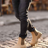 Men's beige suede boots with pull-on elastic panels and rugged lug sole.