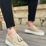 Beige suede loafers with tassel detail and white rubber sole