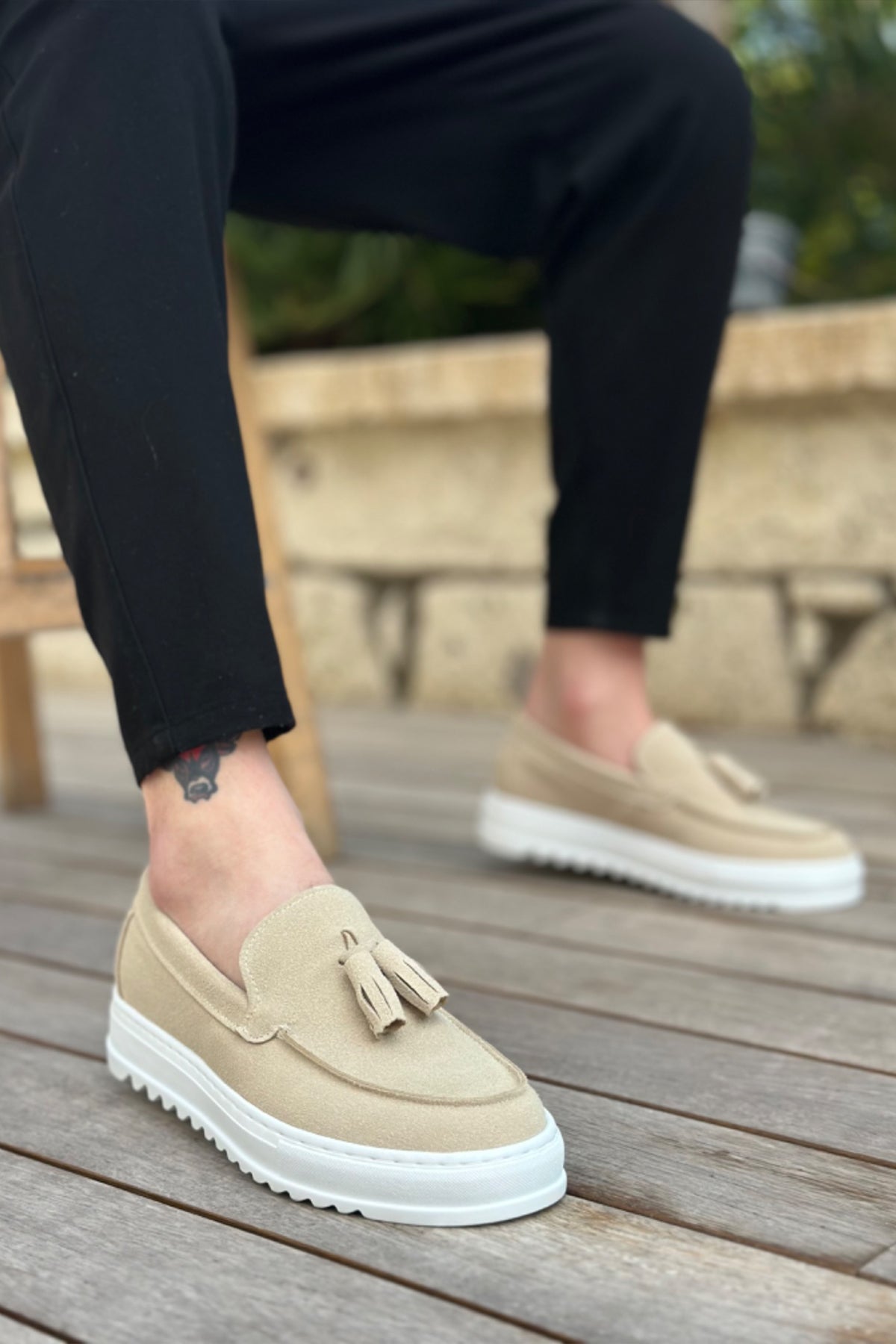 Beige suede loafers with tassel detail and white rubber sole