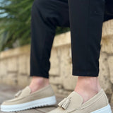 Beige suede loafers, side angle with tassel and textured white sole