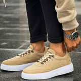 Beige suede lace-up sneakers with white rubber sole, side view
