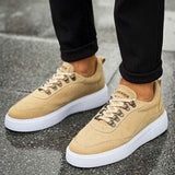 Beige suede sneakers with white sole and laces, front-facing pair view