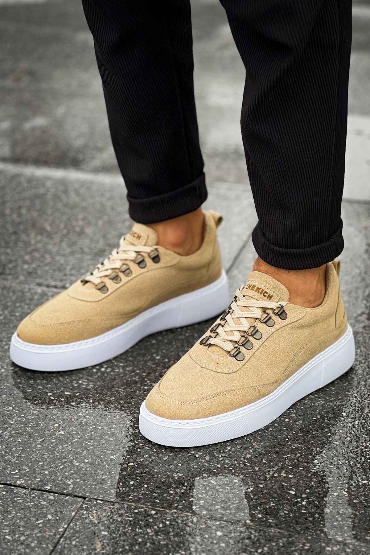 Beige suede sneakers with white sole and laces, front-facing pair view