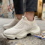 Beige suede slip-on sneakers with chunky white sole and textured side panels
