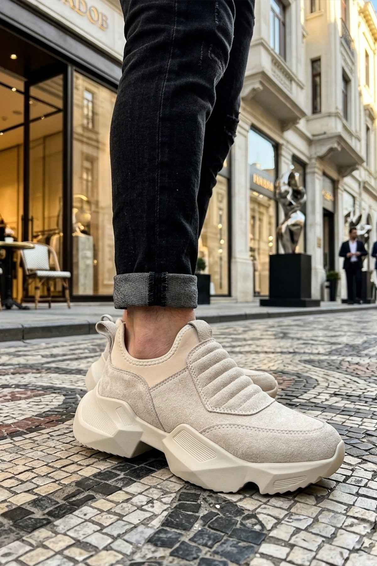 Beige suede sneakers with ridged slip-on strap and thick geometric outsole