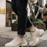 Beige suede sneakers with elastic side inserts and chunky platform heel