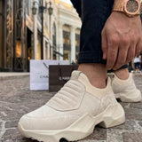 Beige suede sneakers with elastic side panels and chunky sole, front view