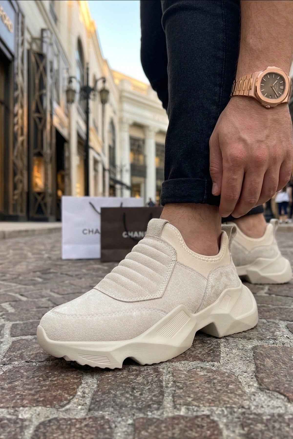 Beige suede sneakers with elastic side panels and chunky sole, front view