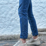 Beige suede lace-up sneakers with chunky ridged rubber sole, side profile