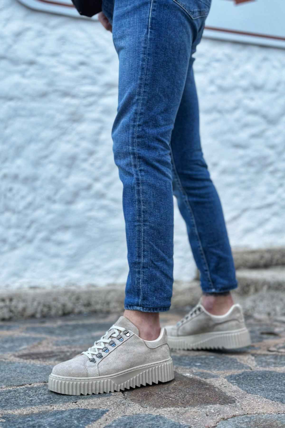 Beige suede lace-up sneakers with chunky ridged rubber sole, side profile