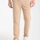 Beige men’s sweatpants with drawstring waist and side pockets