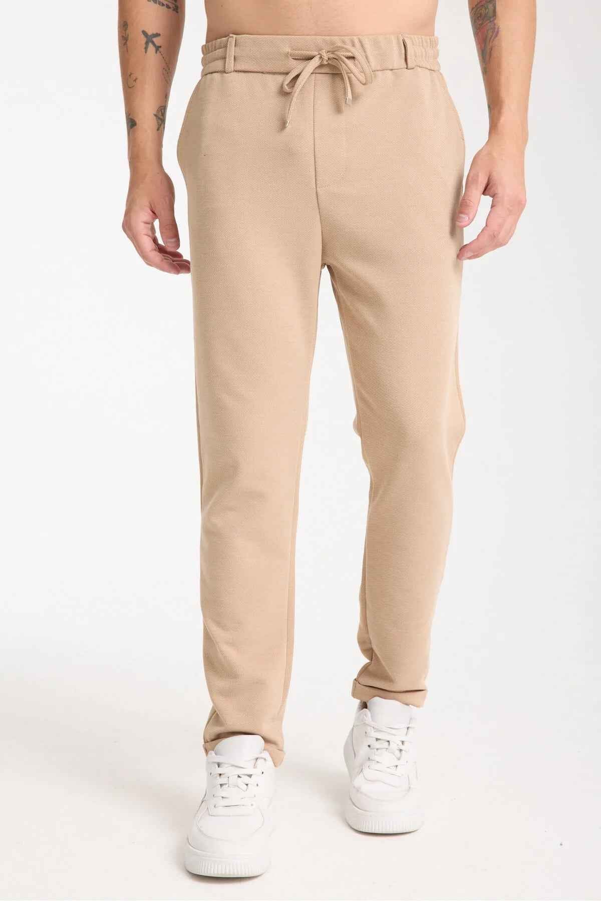 Beige men’s sweatpants with drawstring waist and side pockets