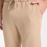 Beige sweatpants with elastic waistband and adjustable drawstring