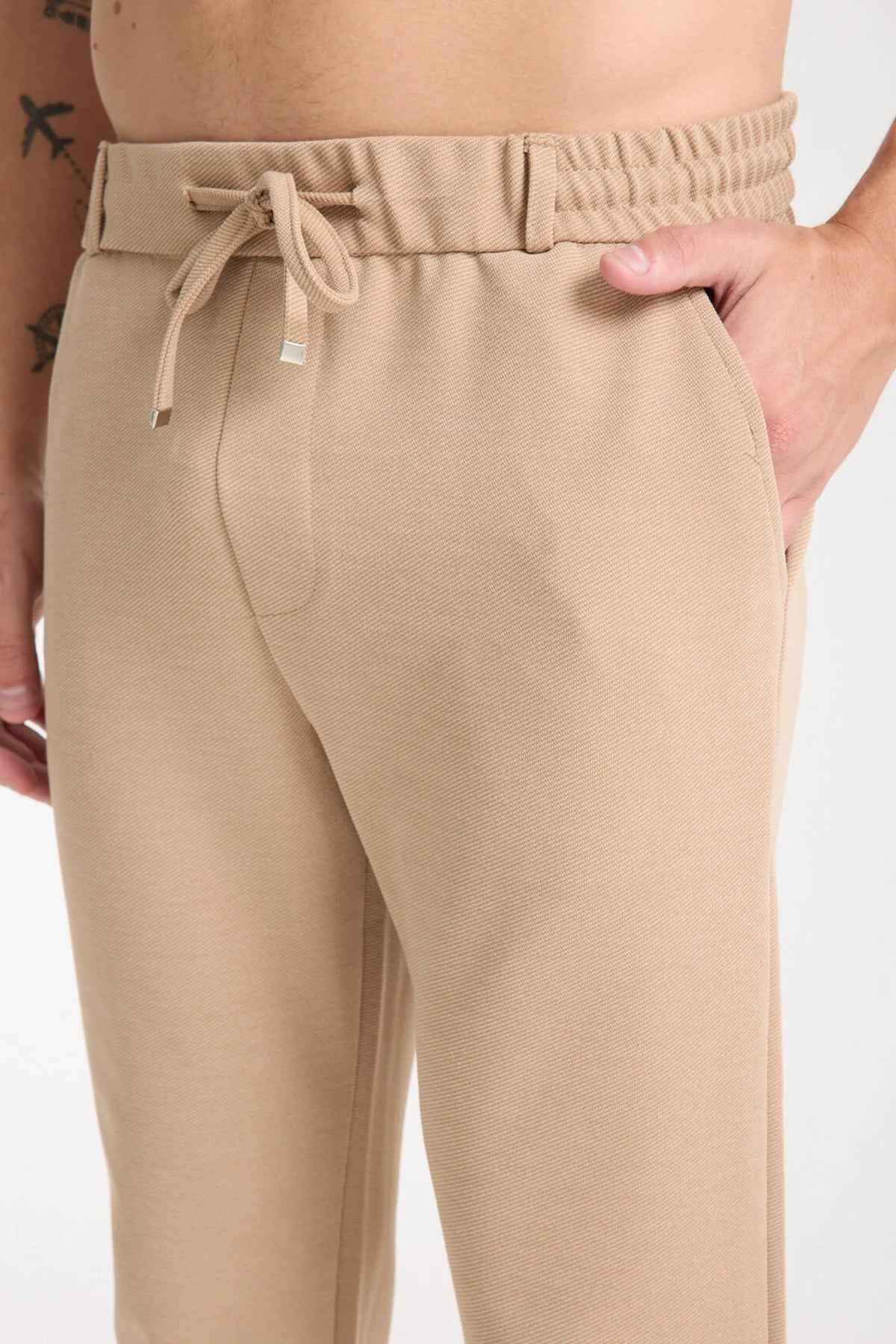 Beige sweatpants with elastic waistband and adjustable drawstring