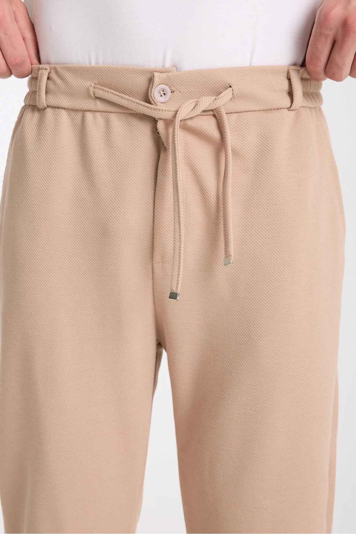 Beige sweatpants with buttoned waistband and drawstring front