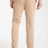 Beige sweatpants with tapered leg and side pocket detail