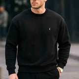 Black crewneck sweatshirt with small chest logo, ribbed cuffs and hem