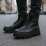 Men's black lace-up ankle boots with lug sole, thick tread and stitched panels