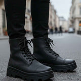 Men's dark lace-up boots with round toe, thick rubber sole and visible stitching