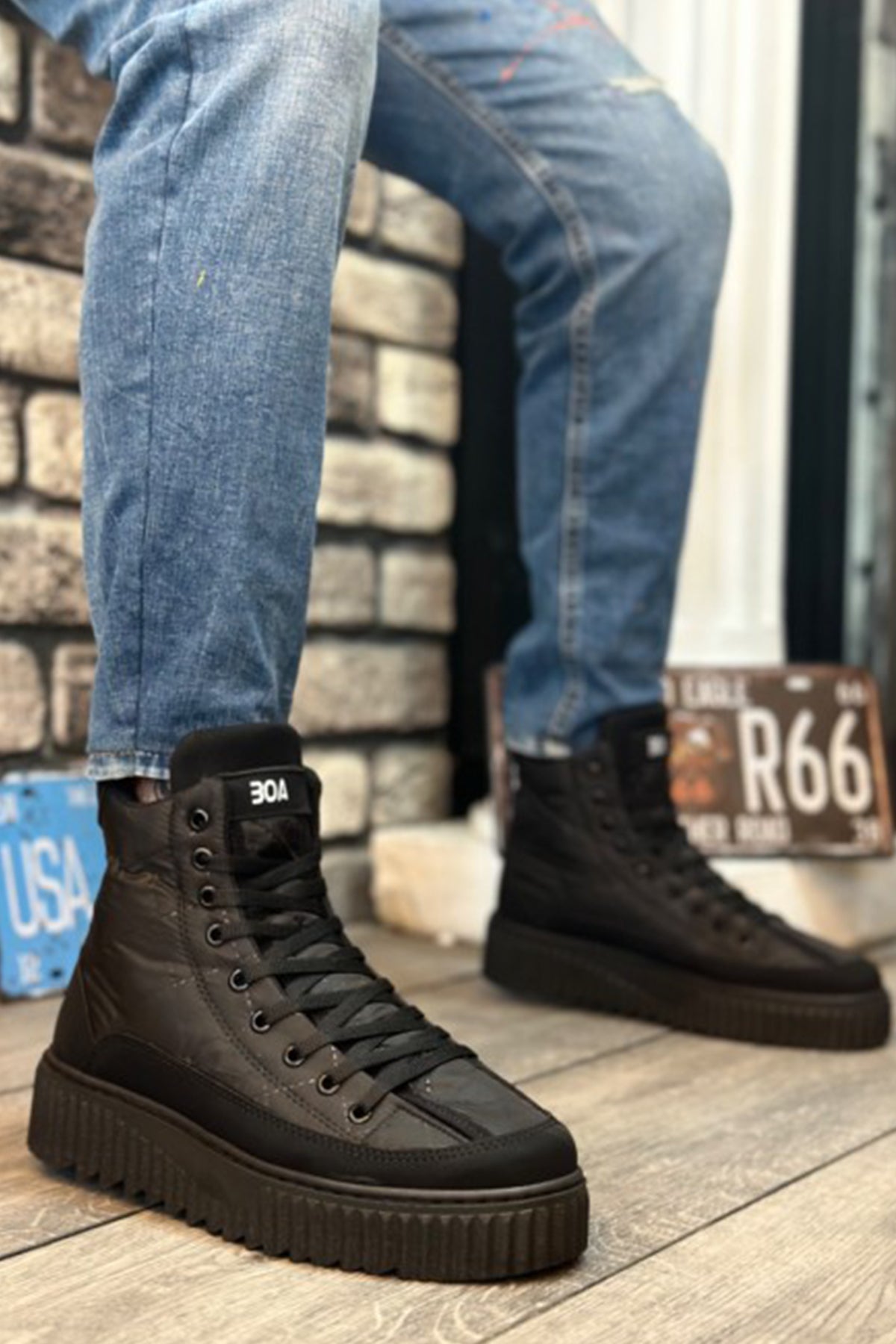 Black lace-up ankle boots with padded collar and tread sole