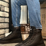 Black lace-up ankle boots, side view, rubber tread sole and lace eyelets