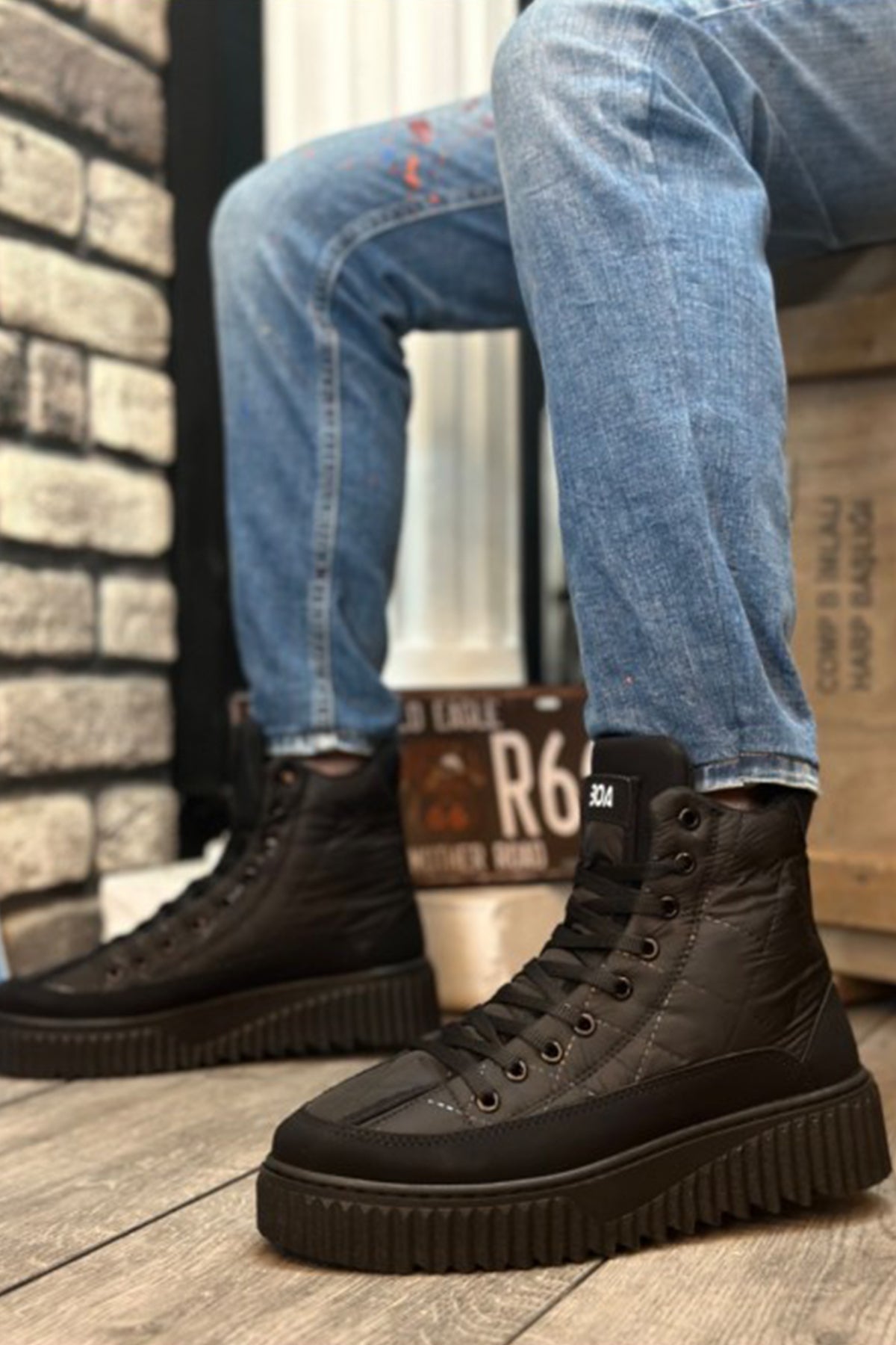 Black lace-up ankle boots, side view, rubber tread sole and lace eyelets