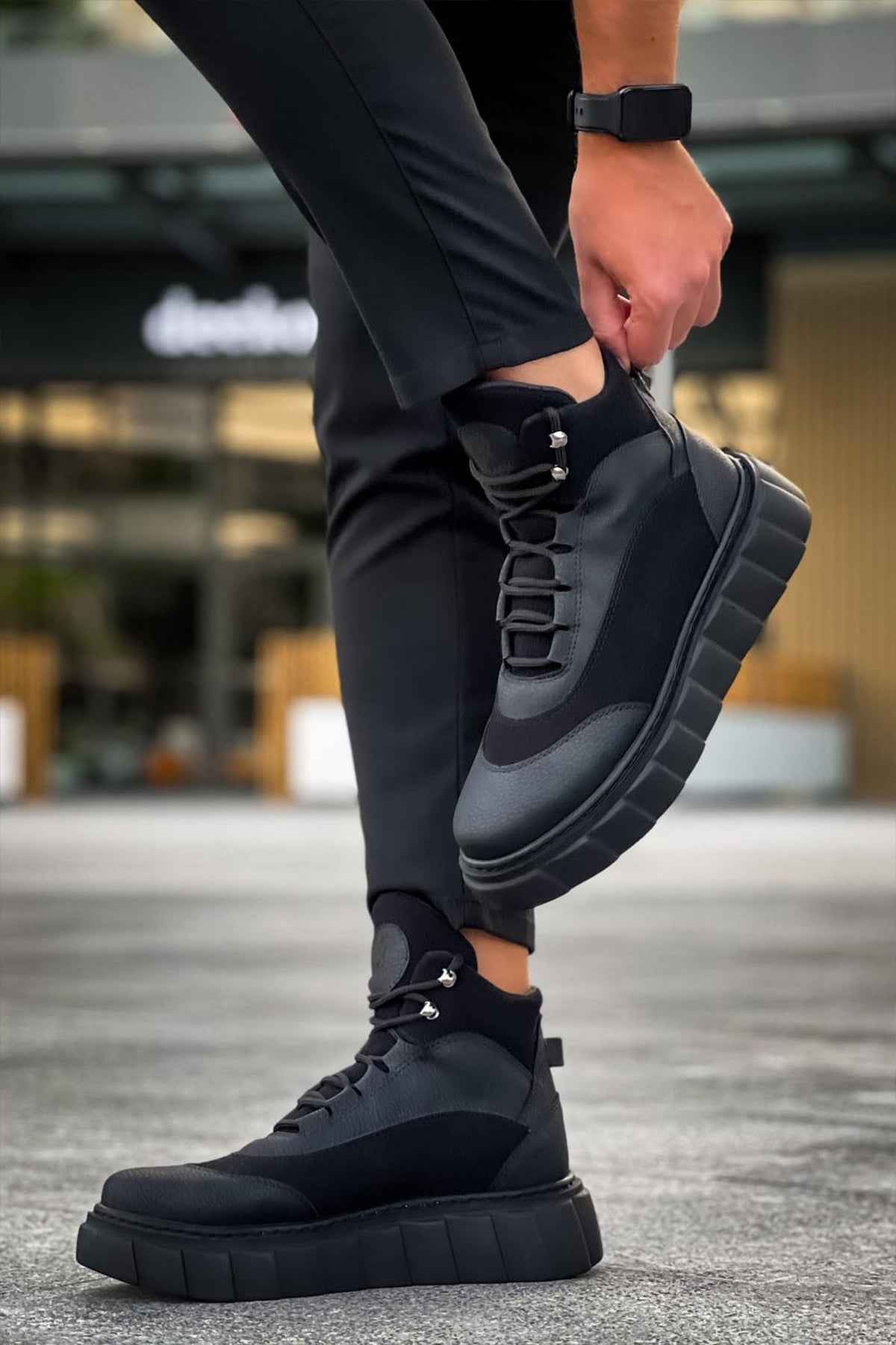 Black lace-up ankle boots with textured sole tread and gray side accents