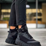Black lace-up boots showing thick tread sole and black ankle pull tab