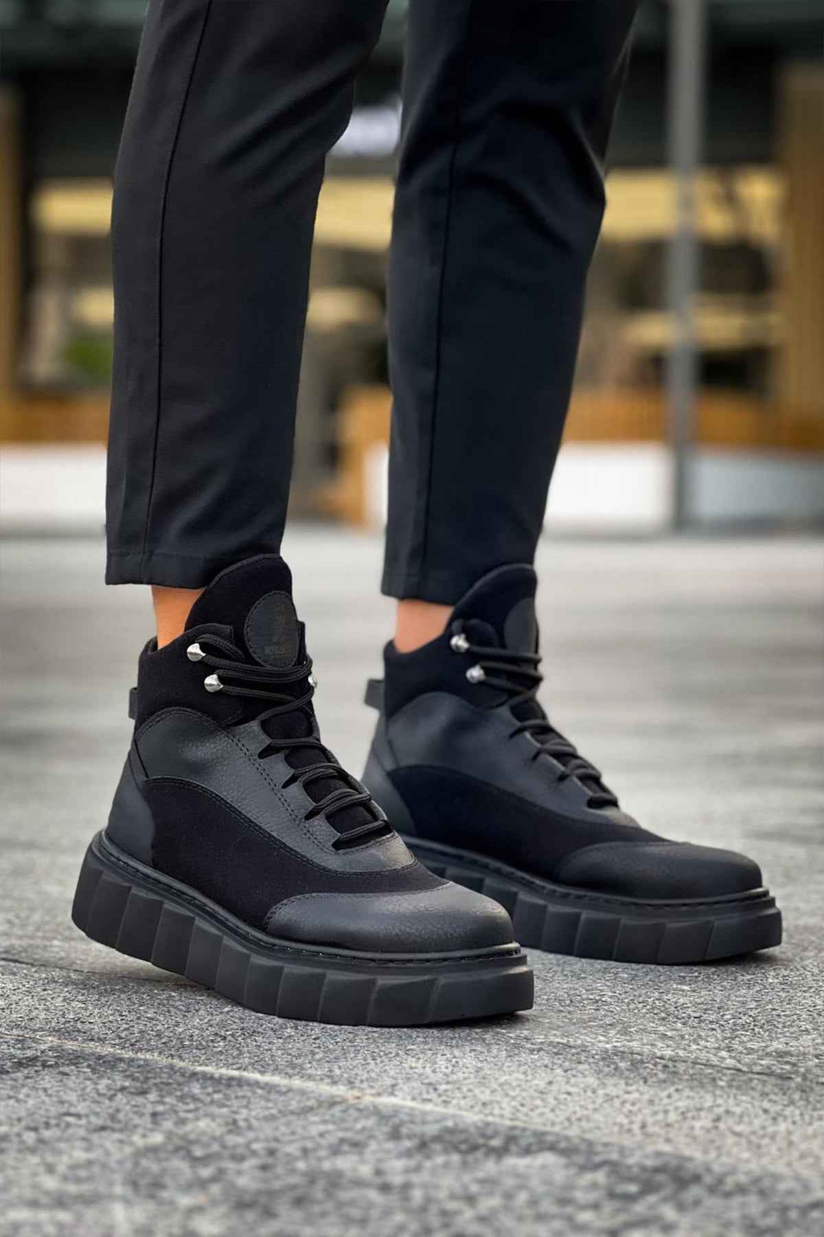Black lace-up ankle boots with gray side panels and chunky outsole blocks
