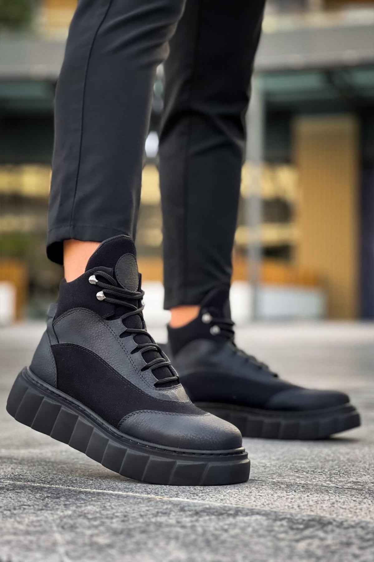 Black lace-up boots with gray paneling and thick block sole