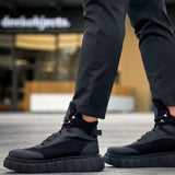 Black lace-up boots with chunky rubber sole and lace-up eyelets