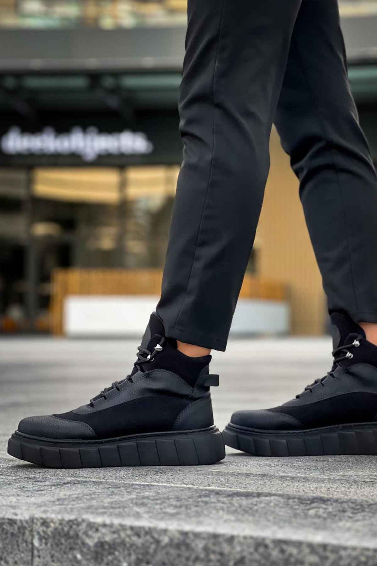Black lace-up boots with chunky rubber sole and lace-up eyelets