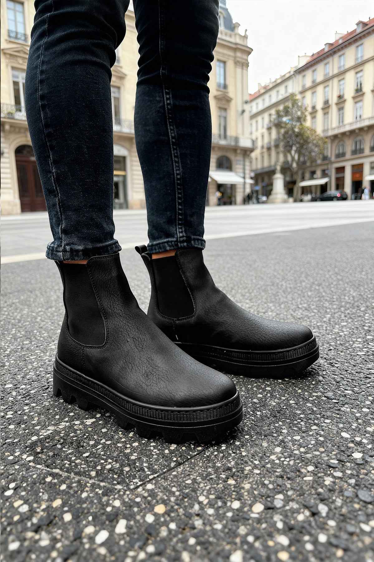 Men's black Chelsea boots with rounded toe and treaded sole