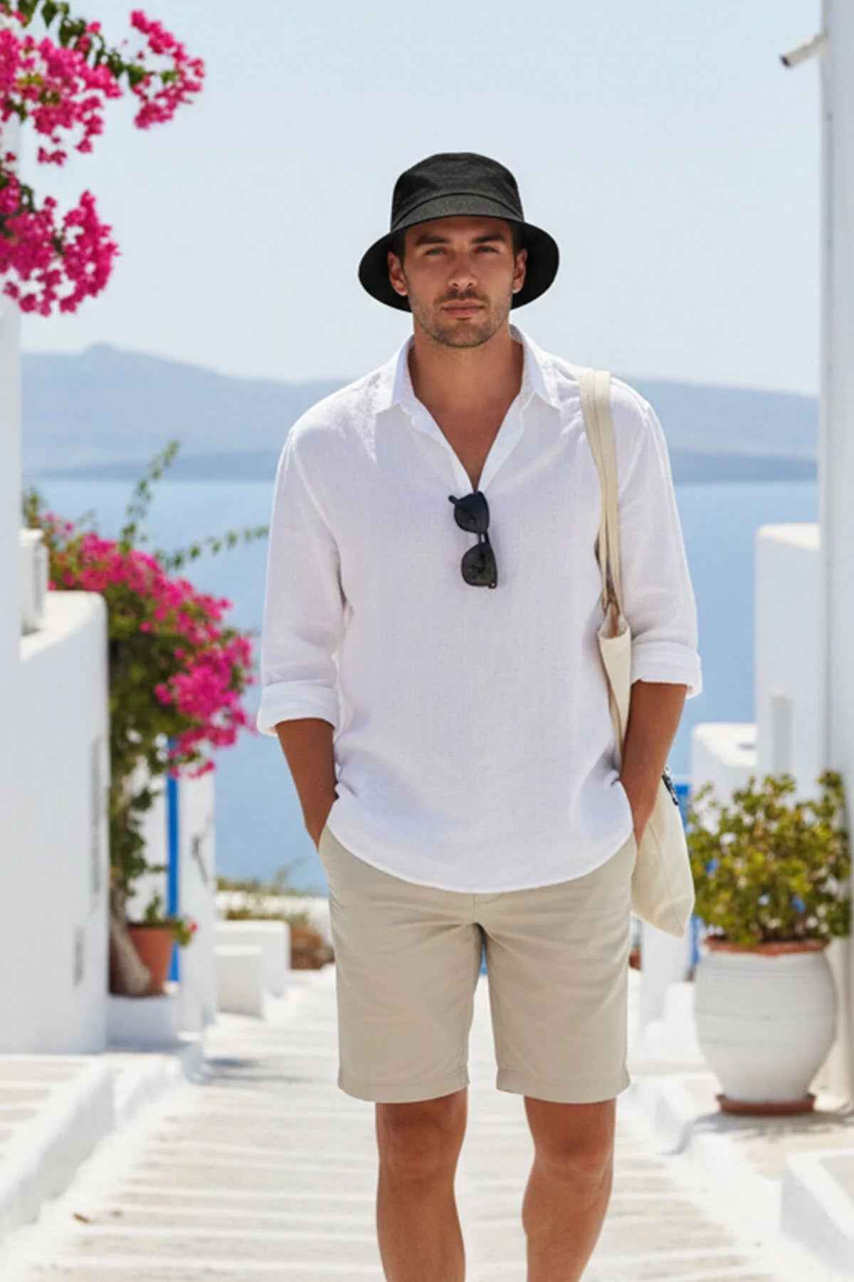 Men's black bucket hat with wide brim, worn.