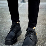 Men's black ankle lace-up boots with low-profile heel and grippy outsole