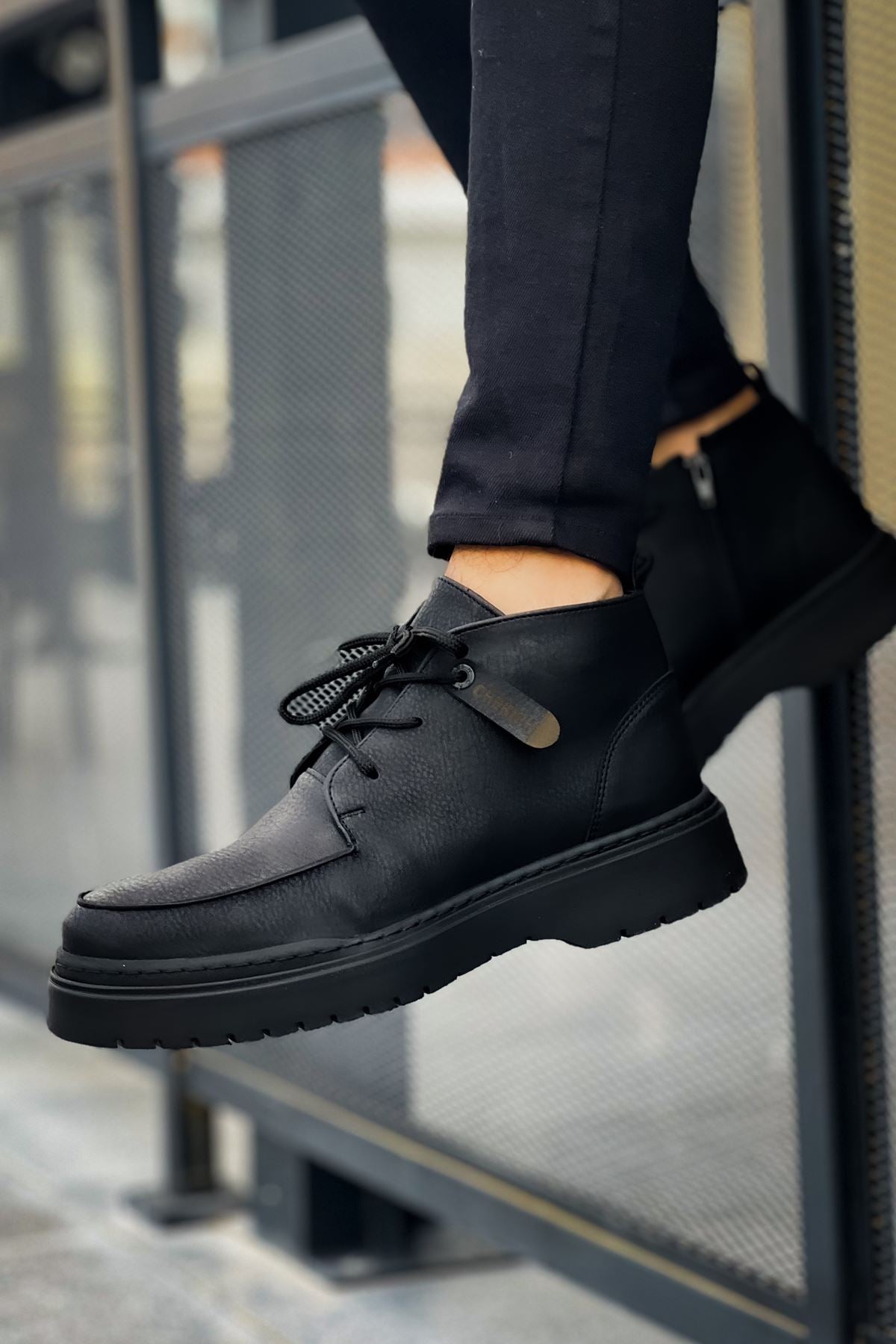 Men's black lace-up casual boots with textured upper and thick tread sole