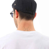 Men's black flat cap from the back, curved brim and crown