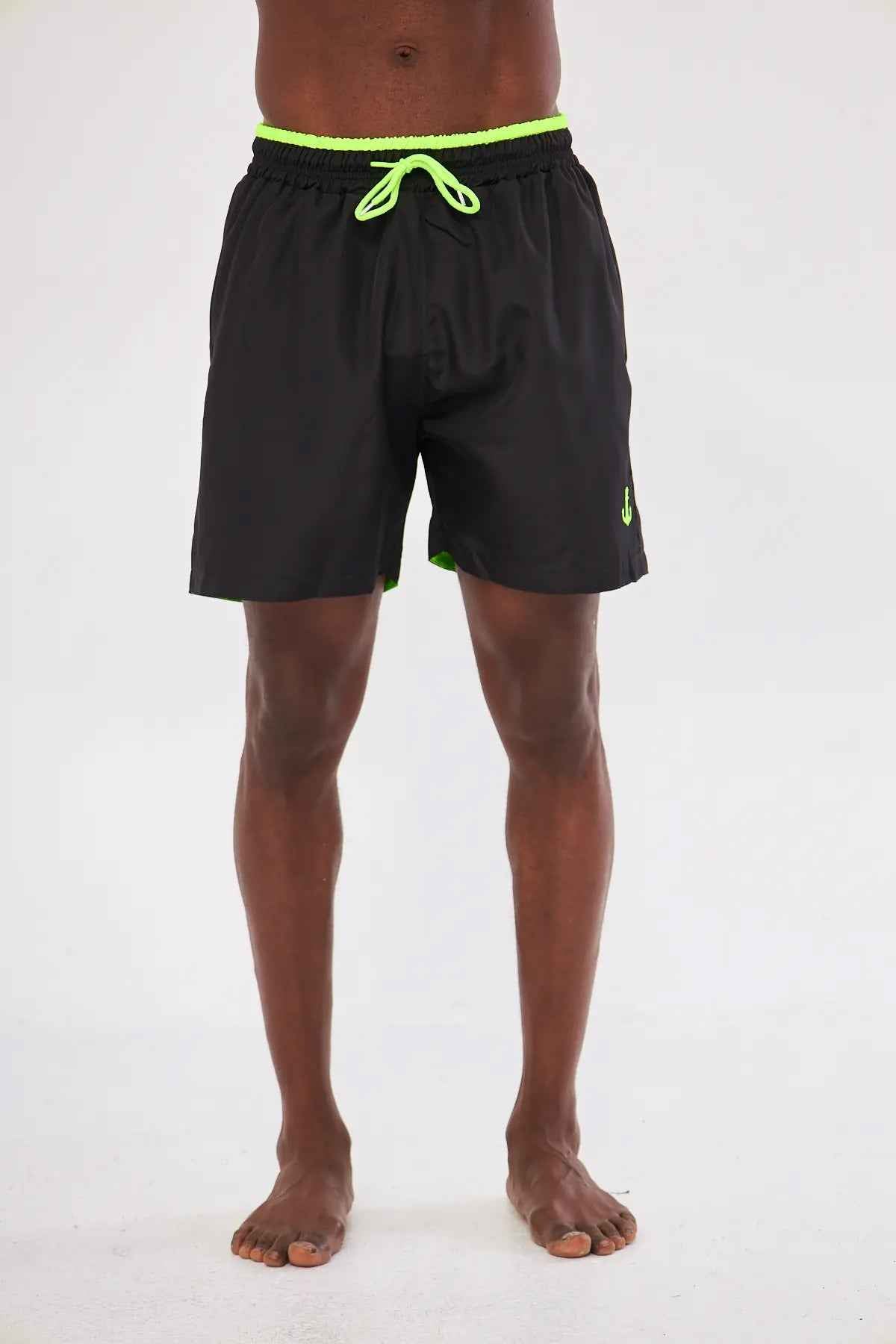 Men's black swim shorts with neon green drawstring waistband detail