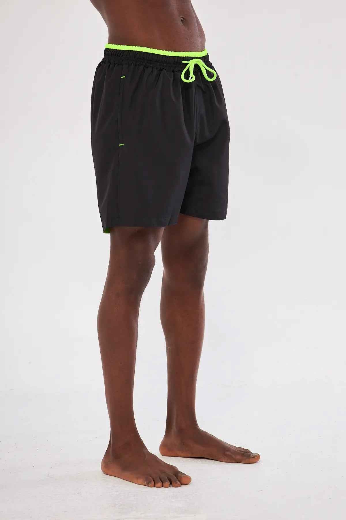 Men's black swim shorts with neon green drawstring and side seams