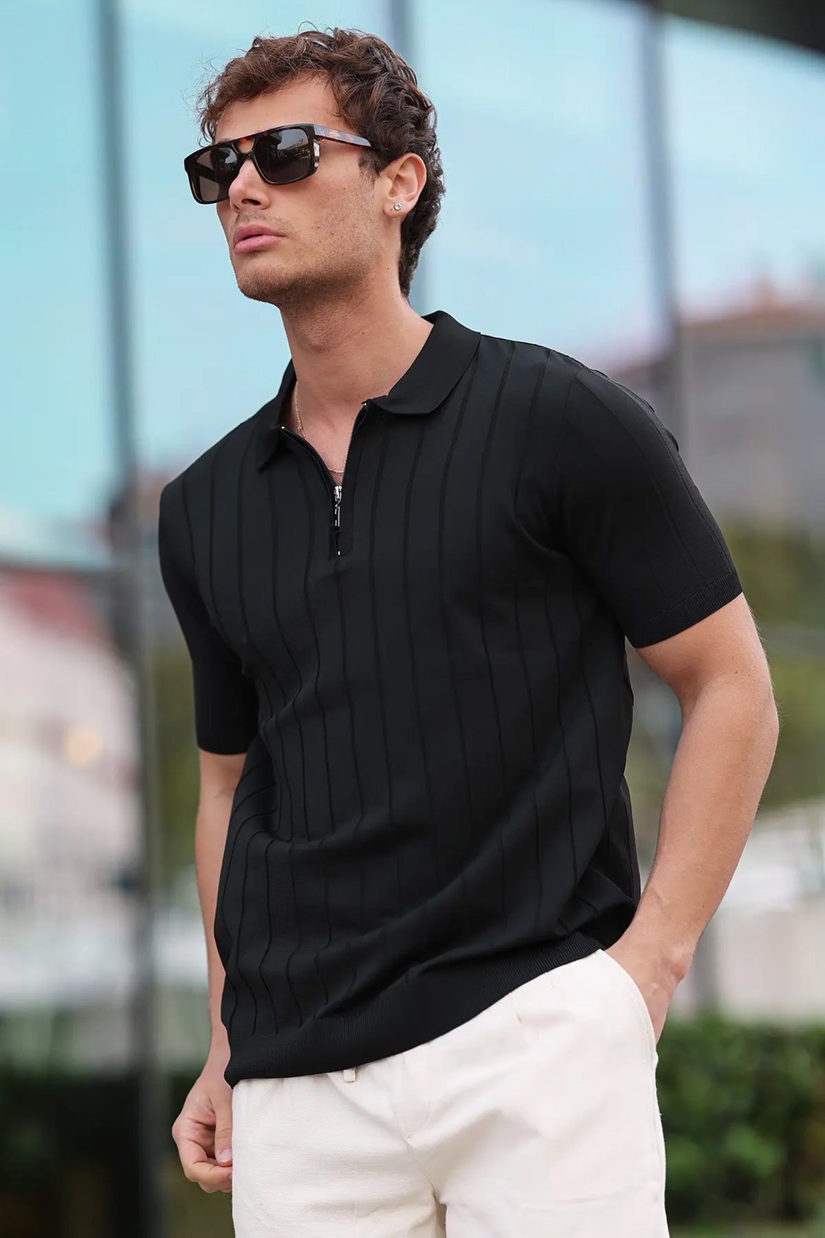 Men's black half-zip polo shirt with short sleeves, ribbed collar, and vertical stripe knit
