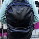 Black leather backpack with front zip pocket and adjustable shoulder straps