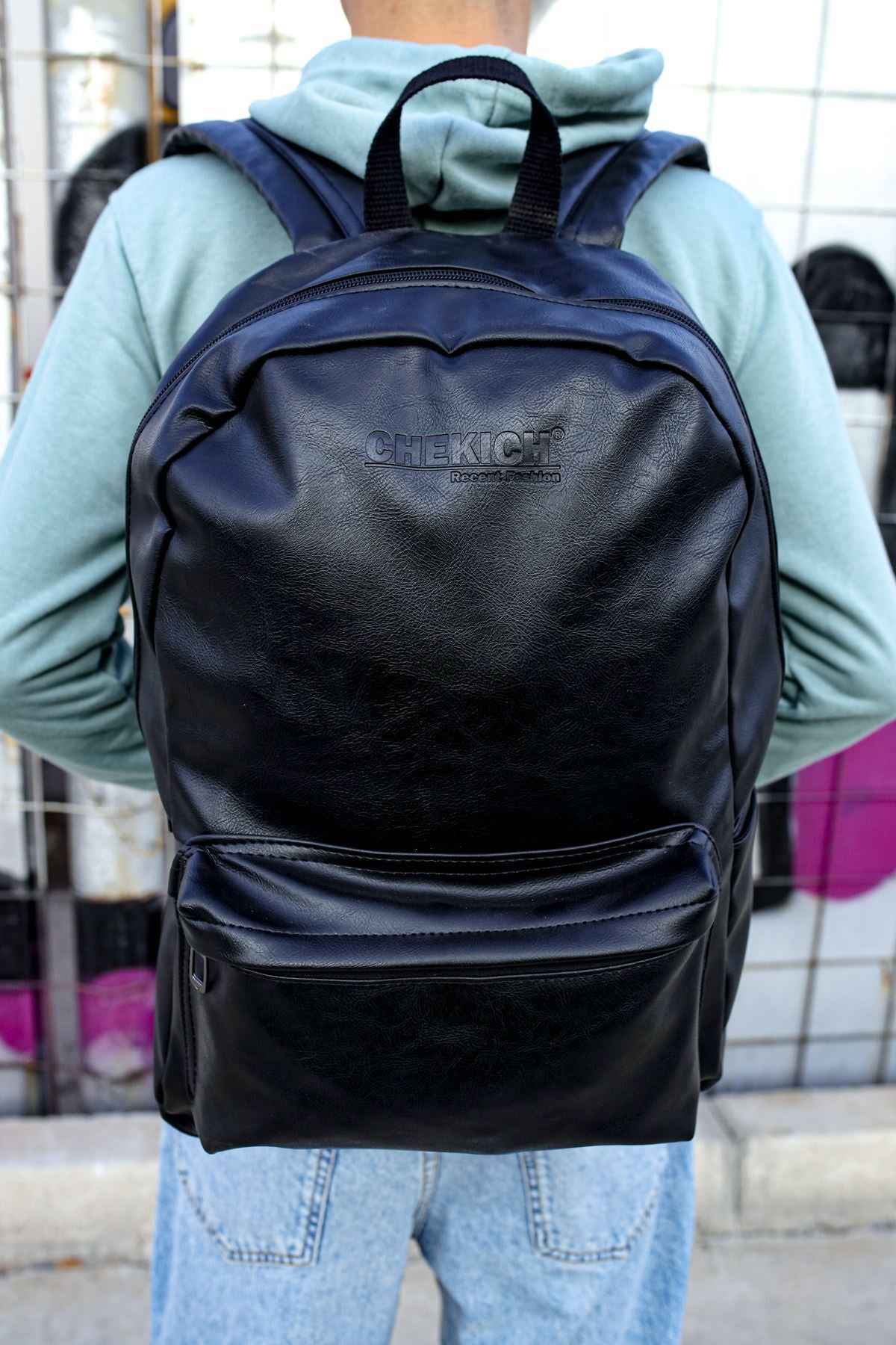 Black leather backpack with front zip pocket and adjustable shoulder straps