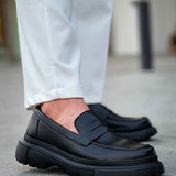 Black loafer with strap detail and chunky tread sole