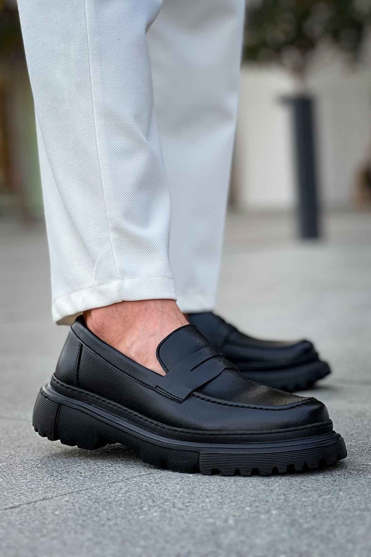 Black loafer with strap detail and chunky tread sole