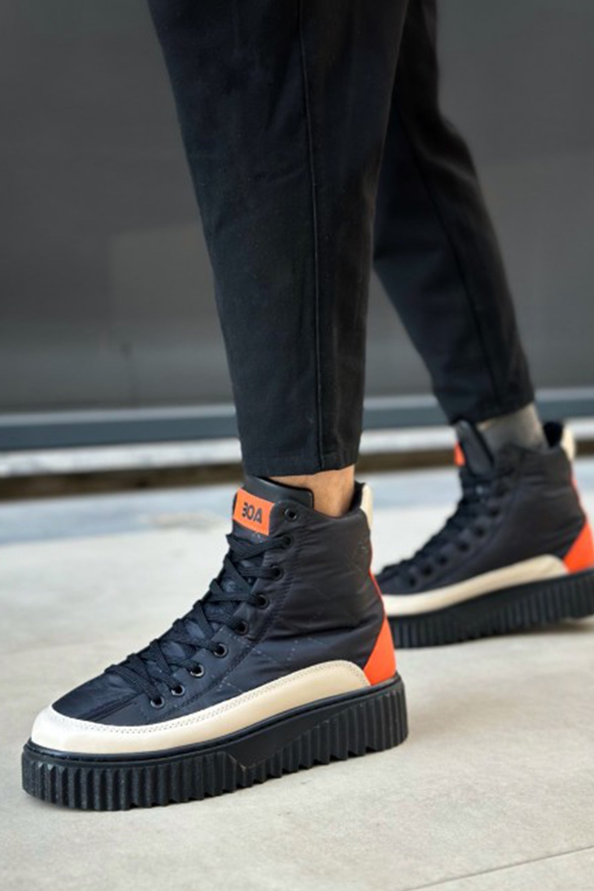 Men's lace-up boots in dark navy with orange accents and white toe, chunky tread sole