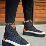 Men's lace-up boots with orange heel tab, dark navy upper, white toe cap, thick tread sole